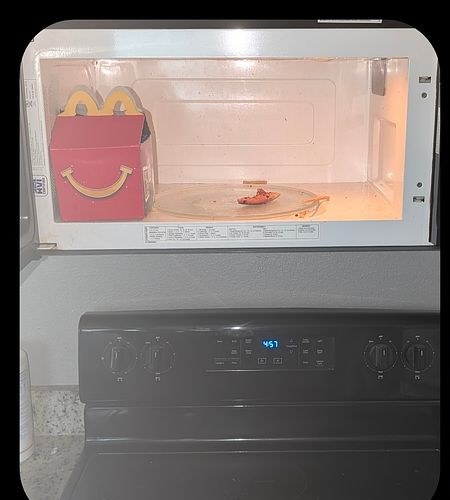 Microwave before cleaning — food debris left behind