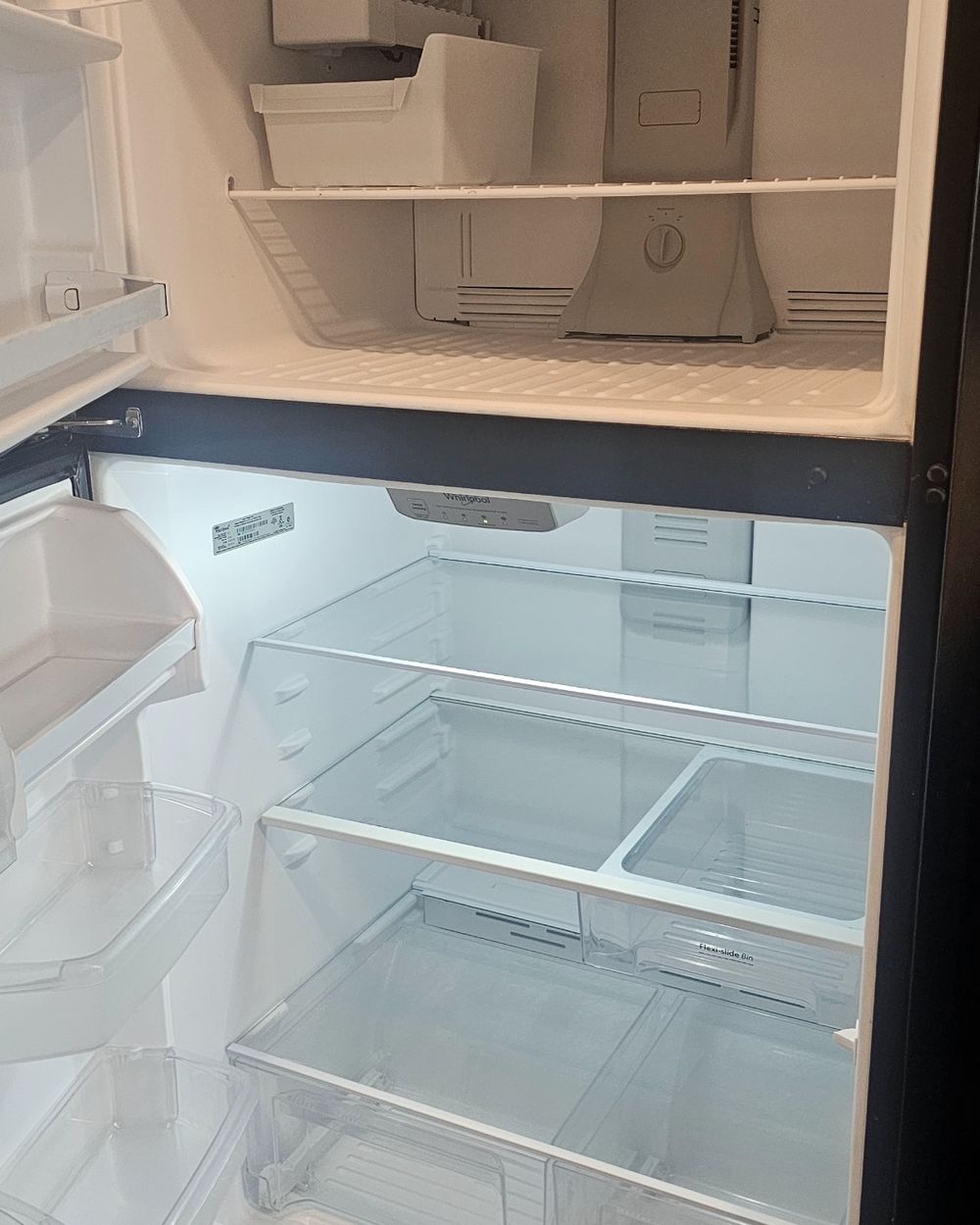 Refrigerator after cleaning — emptied, detailed, and inspection-ready