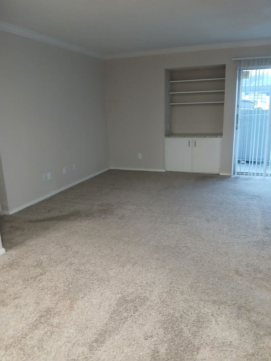 Room with beige shelving after cleaning — dusted and detailed
