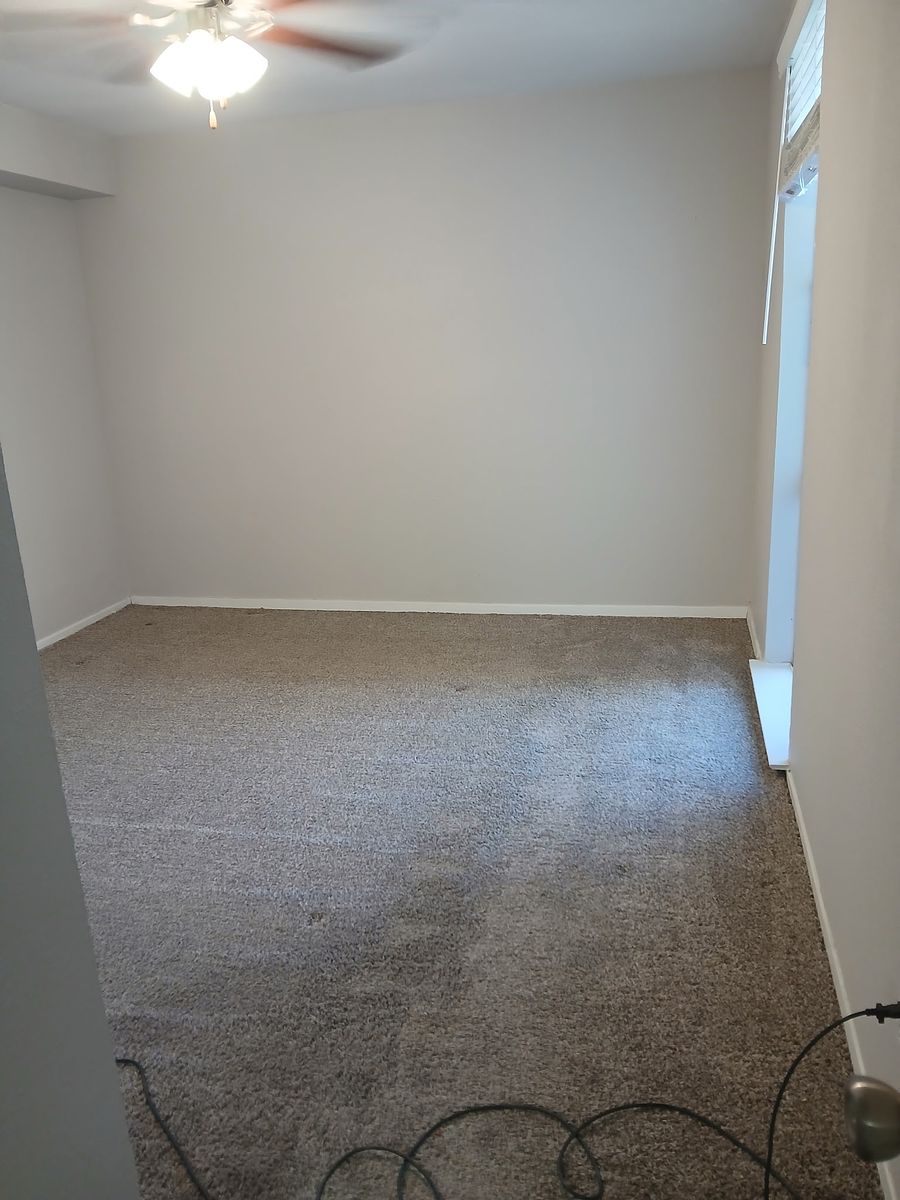 Room with ceiling fan after cleaning — fan dusted, room detailed