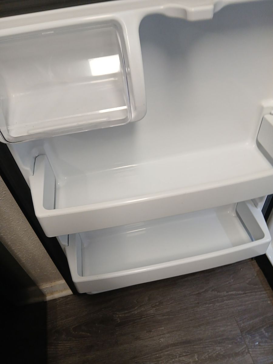 Refrigerator interior after cleaning — clean, dry, and ready to show