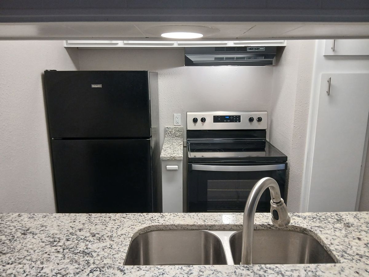 Kitchen with black appliances after cleaning — smudge-free finish