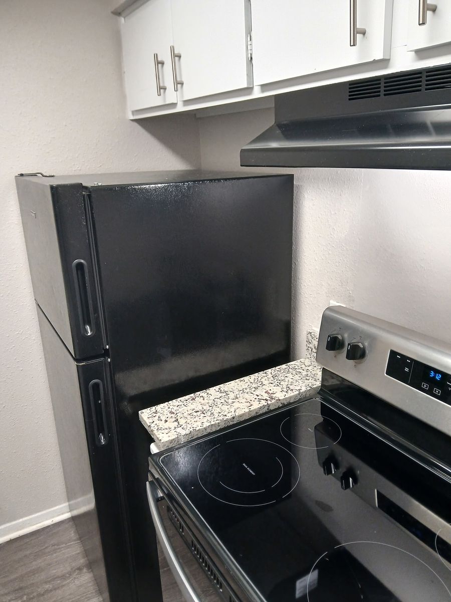 Kitchen corner with black appliances after cleaning — no crumbs, no smudges