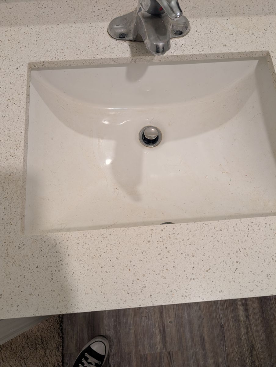 Bathroom vanity before cleaning — toothpaste and residue