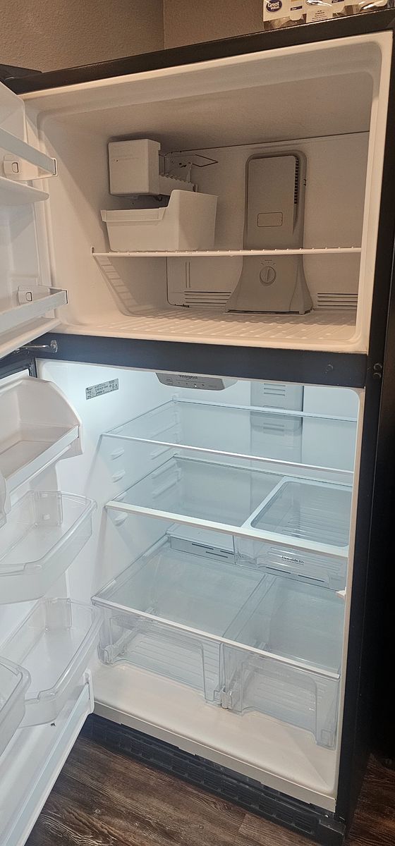 Refrigerator after cleaning — emptied, detailed, and inspection-ready