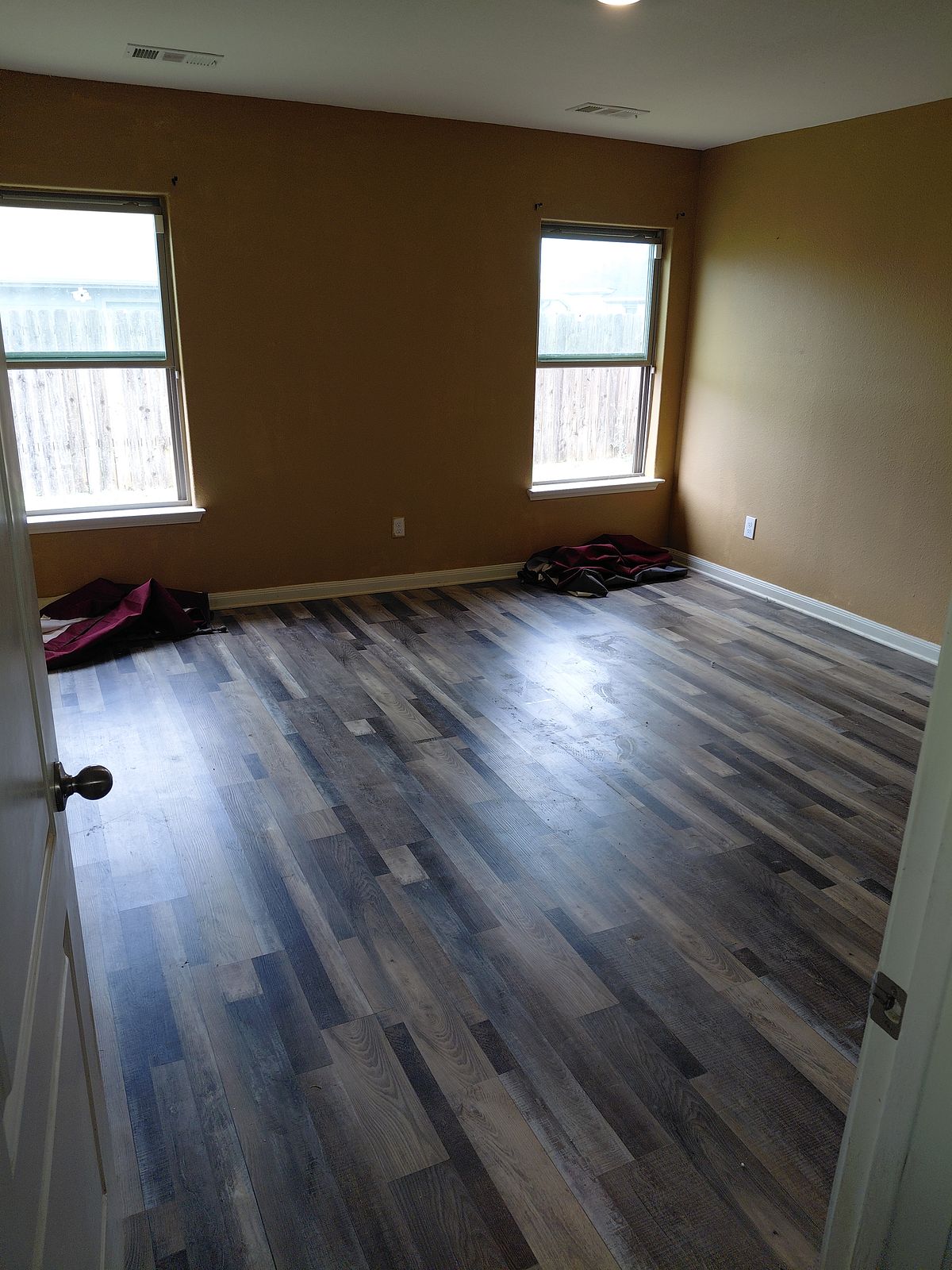 Living room before cleaning — surfaces and floors left dirty