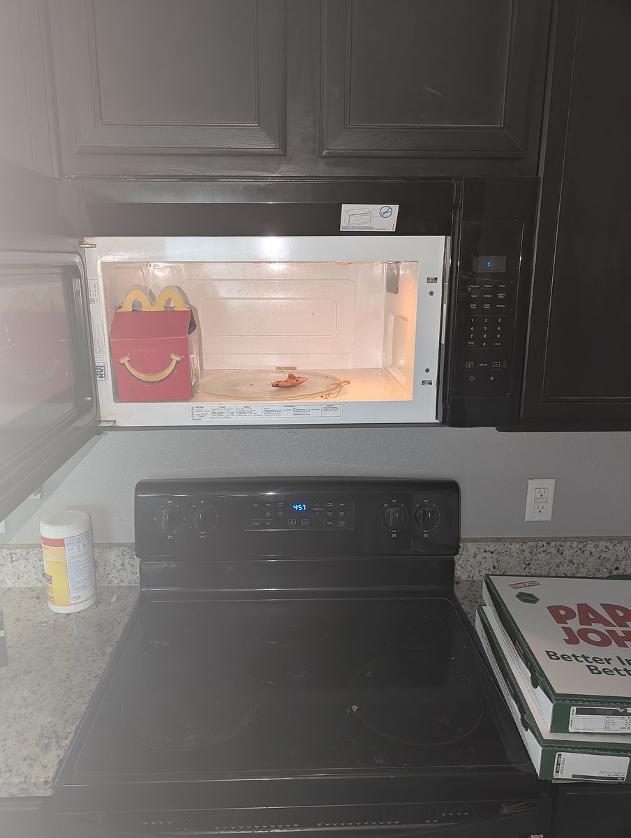 Microwave before cleaning — food debris left behind
